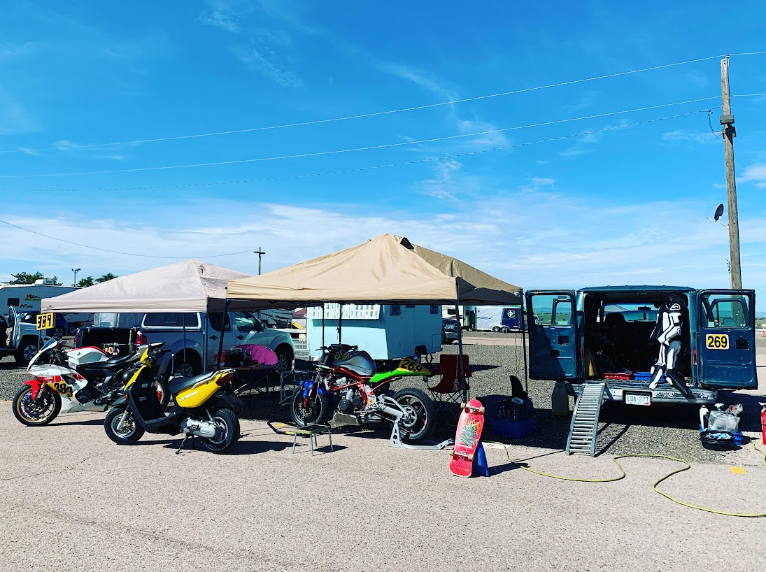 Pit set up with 2x canopies, a Yamaha R7, Ninja 650, and Yamaha Zuma