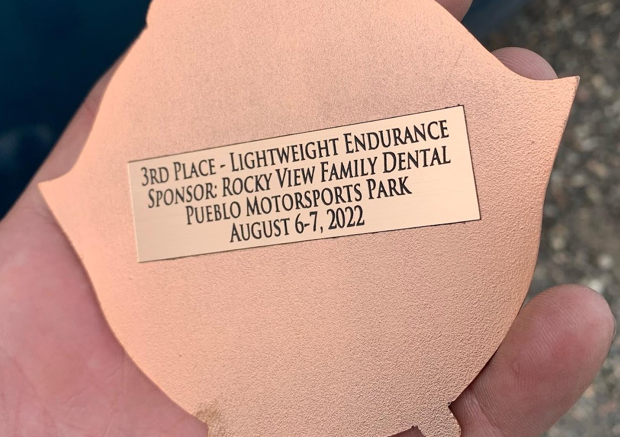 Back of 3rd place trophy, it says "3rd place - Lightweight Endurance, Sponsor: Rocky View Family Dental, Pueblo Motorsports Park August 6-7 2022"