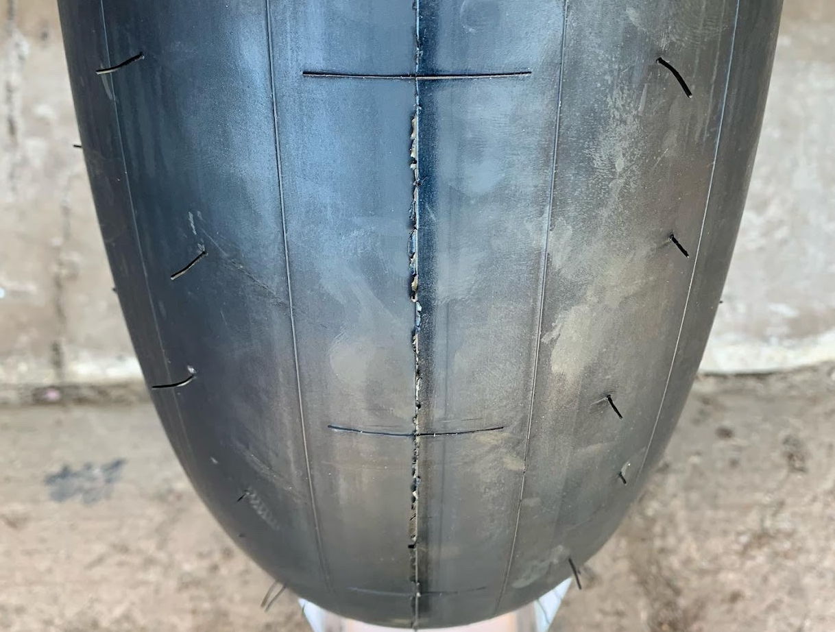 New slick tire with dot-shaped tire wear markers and molding marks 